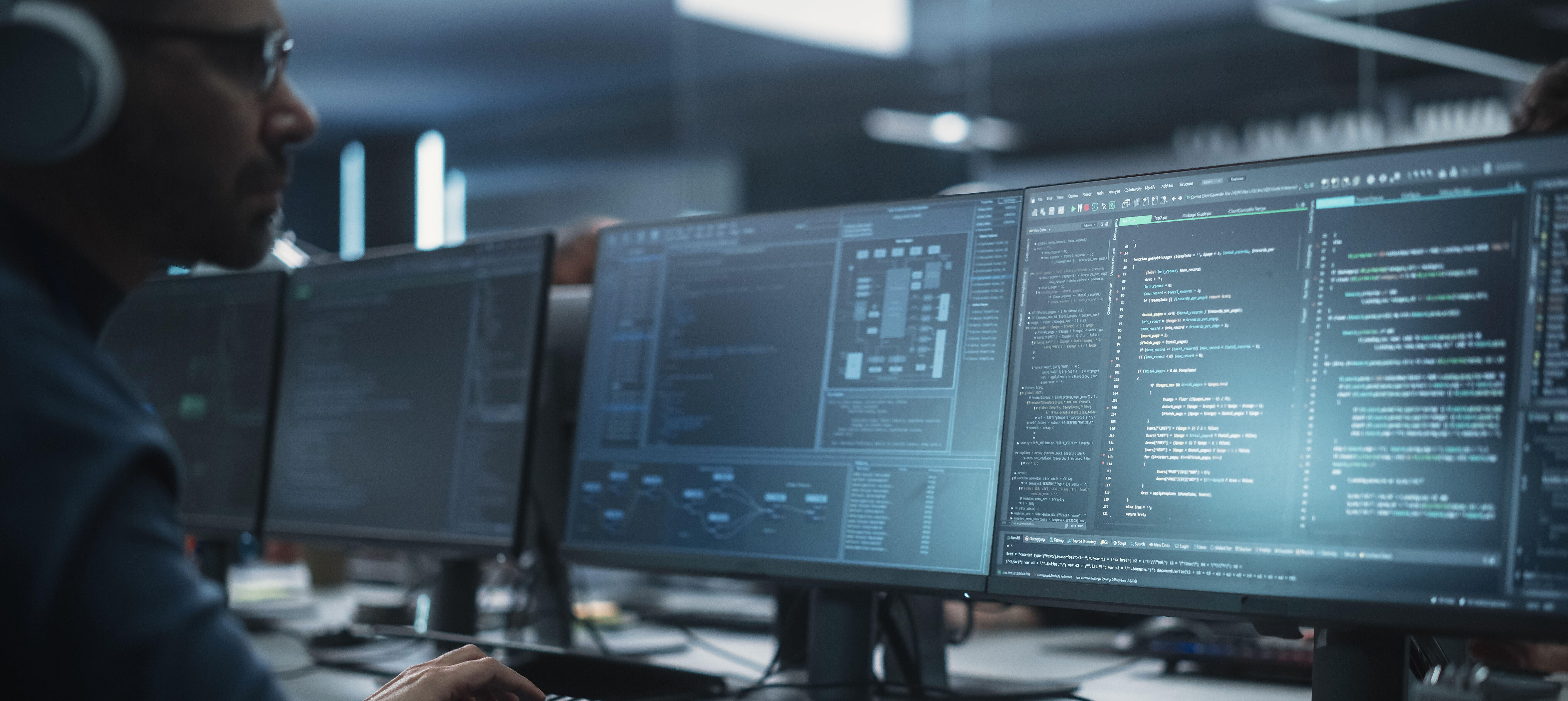 Software Developer working on a desktop computer, implementing new features and updates to a company server.